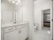 Modern bathroom features a large mirror, white cabinetry, and tiled floors at 9567 Meadow Hunt Way, Winter Garden, FL 34787
