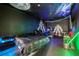 The bedroom features black walls and ceiling with cosmic theme art and a bed at 9567 Meadow Hunt Way, Winter Garden, FL 34787