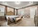 Large bedroom featuring patterned wallpaper, wooden furniture, and a view into the ensuite bathroom at 9567 Meadow Hunt Way, Winter Garden, FL 34787