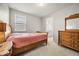 Cozy bedroom featuring a wooden bed frame and matching dresser at 9567 Meadow Hunt Way, Winter Garden, FL 34787
