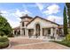 Stunning clubhouse with stone and stucco facade, elegant archway entrance, and well-maintained landscaping at 9567 Meadow Hunt Way, Winter Garden, FL 34787