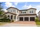 Charming two-story home with three-car garage and beautifully landscaped front yard at 9567 Meadow Hunt Way, Winter Garden, FL 34787