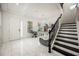 Welcoming foyer with elegant staircase, chandelier, and ample natural light at 9567 Meadow Hunt Way, Winter Garden, FL 34787