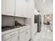 Modern kitchen with white cabinetry, sleek countertops, and stainless steel appliances at 9567 Meadow Hunt Way, Winter Garden, FL 34787