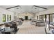 Bright community lounge with modern furniture and ample natural light at 9567 Meadow Hunt Way, Winter Garden, FL 34787
