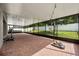 A screened-in patio contains a basketball hoop and exercise equipment at 9567 Meadow Hunt Way, Winter Garden, FL 34787