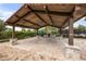 Outdoor pavilion with stone fireplace, ample seating, and a wooden roof providing shade for gatherings at 9567 Meadow Hunt Way, Winter Garden, FL 34787