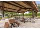 Covered picnic area with multiple picnic tables, stone pillars, and landscaping at 9567 Meadow Hunt Way, Winter Garden, FL 34787