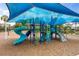 Playground with a blue shade structure, slides, climbing structures, and a soft mulch surface for safety at 9567 Meadow Hunt Way, Winter Garden, FL 34787