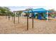 Community playground featuring swings, a blue shade structure, climbing structures and slides for  at 9567 Meadow Hunt Way, Winter Garden, FL 34787