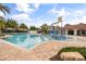 Beautiful community pool with splash pad, covered seating, and lush landscaping for Gathering fun at 9567 Meadow Hunt Way, Winter Garden, FL 34787