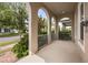 Inviting front porch with stylish arches and white railing, perfect for relaxing outdoors at 9567 Meadow Hunt Way, Winter Garden, FL 34787