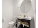 A simple powder room has a toilet, sink, mirror, and light fixture at 9567 Meadow Hunt Way, Winter Garden, FL 34787