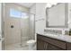 Bathroom featuring granite countertops, modern fixtures, and a glass walk-in shower at 9820 Bucklow Hill Dr, Orlando, FL 32832