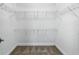 Walk-in closet featuring neutral carpet and built-in wire shelving at 9820 Bucklow Hill Dr, Orlando, FL 32832
