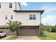 New construction townhome featuring a two-car garage and well-maintained landscaping at 9820 Bucklow Hill Dr, Orlando, FL 32832