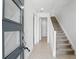 Bright foyer featuring tile flooring, a staircase, and a modern front door at 9820 Bucklow Hill Dr, Orlando, FL 32832