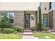 Close-up of townhouse entrances with brick walkways and detailed landscaping at 9820 Bucklow Hill Dr, Orlando, FL 32832