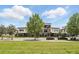Street view of modern townhouses with landscaped front yards and a blue sky backdrop at 9820 Bucklow Hill Dr, Orlando, FL 32832