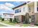 Well-maintained townhouses featuring stone accents and landscaped front yards on a sunny day at 9820 Bucklow Hill Dr, Orlando, FL 32832