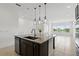 Stylish kitchen island with granite countertop, pendant lighting, and an open layout at 9820 Bucklow Hill Dr, Orlando, FL 32832