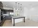 Kitchen island with granite countertop, dark wood cabinets, and modern pendant lights at 9820 Bucklow Hill Dr, Orlando, FL 32832