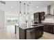 Open kitchen with granite island, stainless steel appliances, and modern pendant lighting at 9820 Bucklow Hill Dr, Orlando, FL 32832