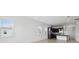 Bright living area with kitchen features, multiple windows, and tile floors at 9820 Bucklow Hill Dr, Orlando, FL 32832