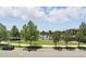 Scenic view of community park with walking path, lake, and landscaping at 9820 Bucklow Hill Dr, Orlando, FL 32832