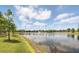 Scenic view of the pond with fountain and lush green surroundings under a blue sky at 9820 Bucklow Hill Dr, Orlando, FL 32832