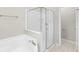 Bright bathroom with a glass enclosed shower, a tub and neutral walls at 9885 Montclair Circle Cir, Apopka, FL 32703