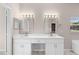 Bathroom with double vanity, modern lighting fixtures, and decorative mirrors at 9885 Montclair Circle Cir, Apopka, FL 32703