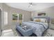 Bright bedroom features a decorative rug, a window with blinds, and a ceiling fan at 9885 Montclair Circle Cir, Apopka, FL 32703