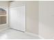 Bedroom featuring sleek tile flooring, double door closet and neutral colored walls at 9885 Montclair Circle Cir, Apopka, FL 32703
