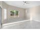 Large bedroom featuring tile floors, a ceiling fan and large windows at 9885 Montclair Circle Cir, Apopka, FL 32703