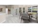 Bright breakfast nook with a round table, modern chairs, and natural light streaming through large windows at 9885 Montclair Circle Cir, Apopka, FL 32703