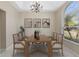 Elegant dining room with a modern chandelier, large window, and seating for six guests at 9885 Montclair Circle Cir, Apopka, FL 32703