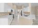 Bright kitchen with white cabinets and modern appliances at 9885 Montclair Circle Cir, Apopka, FL 32703