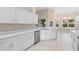 Kitchen featuring stainless steel appliances, quartz countertop and white cabinetry at 9885 Montclair Circle Cir, Apopka, FL 32703