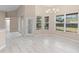 Bright and airy dining room area with light-colored tile, chandelier, and a view to the backyard at 9885 Montclair Circle Cir, Apopka, FL 32703