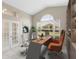 Well-lit home office with a large arched window, modern desk, and ample natural light at 9885 Montclair Circle Cir, Apopka, FL 32703
