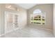 Bright room featuring tile floors, neutral colors, arched window, and glass French doors at 9885 Montclair Circle Cir, Apopka, FL 32703
