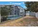 The home's screened in pool sits next to a shed at 1010 Sugarberry Trl, Oviedo, FL 32765