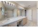 Bright bathroom featuring a double sink vanity, neutral tiling, and a shower/tub combo at 1010 Sugarberry Trl, Oviedo, FL 32765