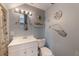 Quaint bathroom with beach-themed decor, white vanity, and tiled walls at 1010 Sugarberry Trl, Oviedo, FL 32765