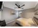 Bedroom with modern style, ceiling fan, wall art, and neutral colors create a calm space at 1010 Sugarberry Trl, Oviedo, FL 32765