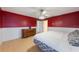 Bedroom featuring bright red walls, white trim, wood floors and stylish decor at 1010 Sugarberry Trl, Oviedo, FL 32765