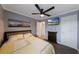 Modern bedroom with a ceiling fan, television, and stylish decor, perfect for relaxation at 1010 Sugarberry Trl, Oviedo, FL 32765
