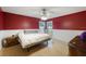Bedroom with red accent wall, wainscoting, and natural light from the windows at 1010 Sugarberry Trl, Oviedo, FL 32765