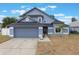 Charming two-story home with a well-maintained lawn and attached two-car garage at 1010 Sugarberry Trl, Oviedo, FL 32765